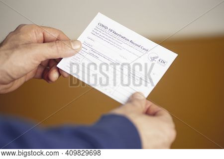 Vaccination Record Card. Vaccination Form During The Coronavirus Epidemic In The Hands Of A Vaccinat