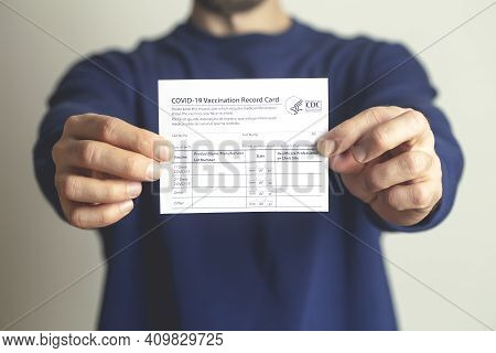Vaccination Record Card. Vaccination Form During The Coronavirus Epidemic In The Hands Of A Vaccinat