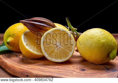 Fresh Ripe Yellow Italian Lemons And Wooden Juice Squeezer, New Harvest