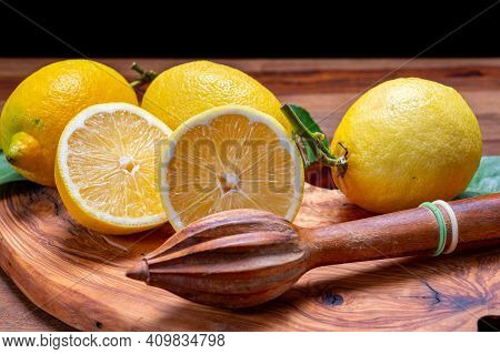 Fresh Ripe Yellow Italian Lemons And Wooden Juice Squeezer, New Harvest
