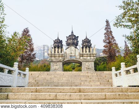 Qingdao, China - December 2017: White Carved Buddhist Archway 'huazang Shijie' As The Entrance To Th