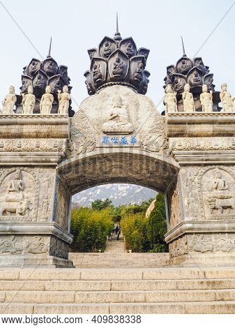 Qingdao, China - December 2017: White Carved Buddhist Archway 'huazang Shijie' As The Entrance To Th