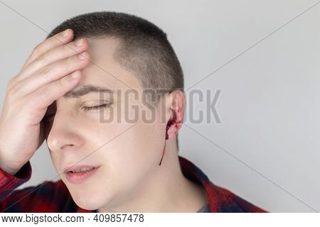 A Man Whose Ear Is Bleeding. Vascular Rupture, Damage To The Tympanic Membrane, Ear Diseases, Oncolo