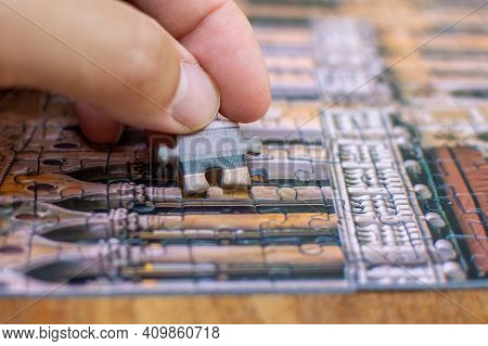 Hand Putting In Lasat Puzzle Piece On A Table For Completion, Final Steps, Finishing Concepts For Pr