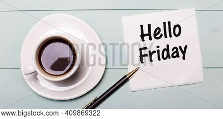 On A Light Blue Wooden Tray, There Is A White Cup Of Coffee, A Handle And A Napkin That Says Hello F