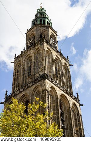 Groningen, The Netherlands - 17 Oct, 2020: The Martini Tower With A Tree In The Front Against The Sk