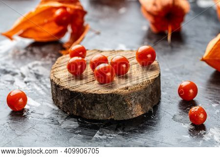 Physalis On Wooden Stump. Ripe Berries Of Autumn Red Physalis Fruit. Berries Fruit. Physalis Or Chin
