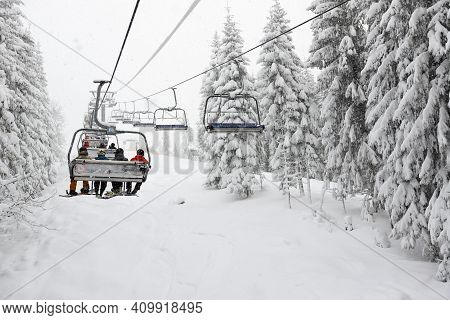 Bukovel, Ukraine - December 25:  The Skiers Are On A Cableway In Bukovel Ski Resort. It Is The Large