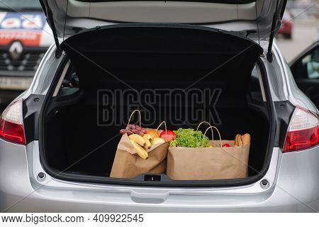 Groceries From A Supermarket In A Car Trunk. Food Delivery During Quarantine. Cruft Paper Eco Bags F