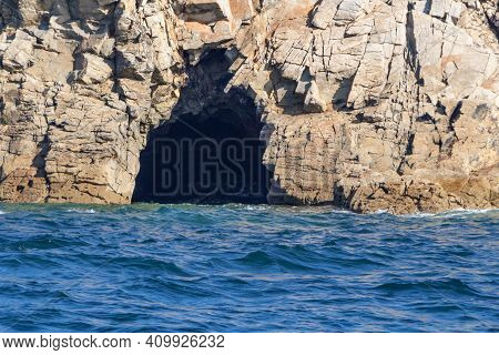 Coast In Brittany With A Cave View From The Sea