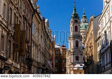Mostecka Street With A View Of Baroque Church Of Saint Nicholas, Old Town With Historical Buildings,