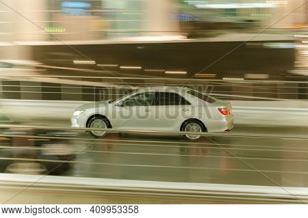 Moscow, Russia - January 22, 2021: Fast Moving Silver Sedan Car With Motion Blur Effect. Overspeed C