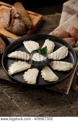 Appetizing Traditional Russian Dumplings, Hand-made With Potatoes. Still Life On A Wooden Board. Clo