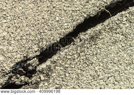Chasm On Old Asphalt Road. Crack And Hiatus On Pavement. Broken Way.