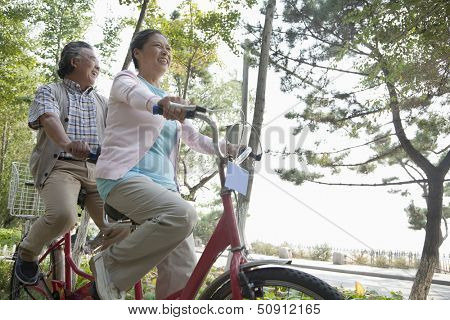 Older couple riding tandem bicycle, Beijing