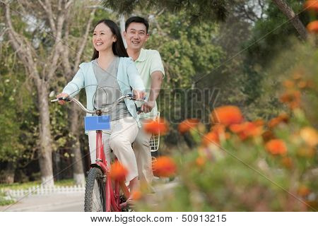Couple riding tandem bicycle in Beijing