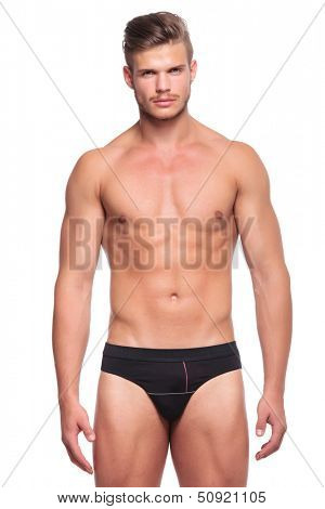 closeup of a young man wearing nothing but his underware, looking at the camera. isolated on white