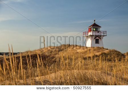 Lighthouse nestled in the sand dunes at Dalvay, in Cavendish National Park, on the north shore of Prince Edward Island, Canada.