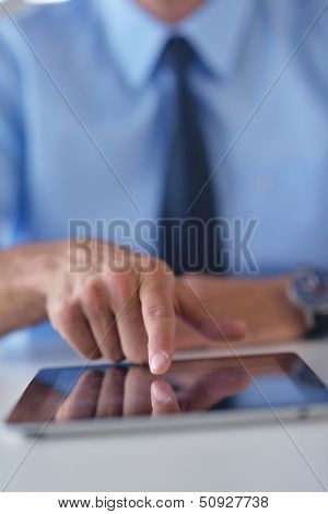 close-up of human hand  business man using tablet compuer at office