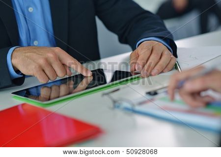 close-up of human hand  business man using tablet compuer at office