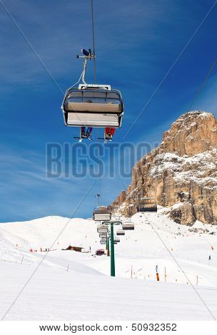Chair lift with skiers at ski resort