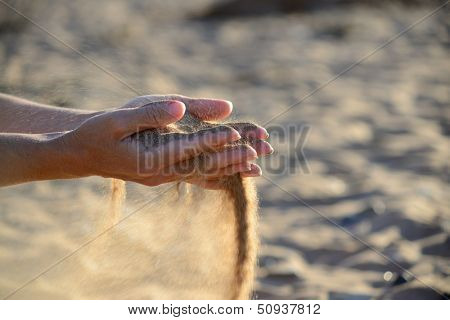 sand pours out of the hands