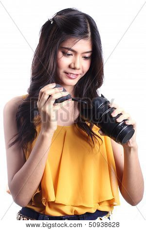 Cute woman cleaning the len