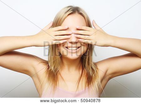teen girl with her hands covering her eyes. close up.