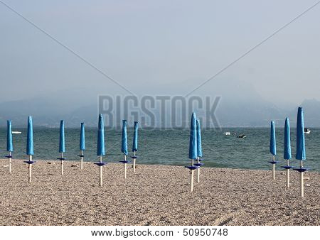 Closed Parasols At Rubble Beach In The Morning