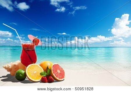 strawberry cocktail and tropical fruit on the beach