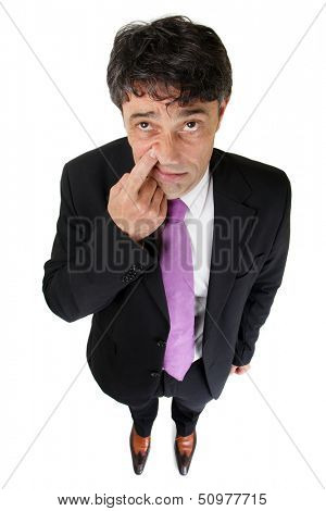 Businessman making a rude dismissive gesture raising his finger to tap the side of his nose or alternatively signaling that - we share a secret