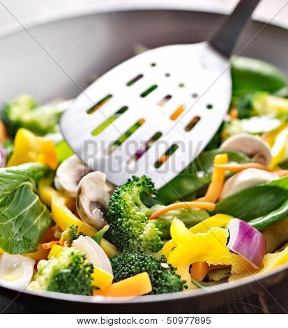vegetarian wok stir fry with metal spatula.