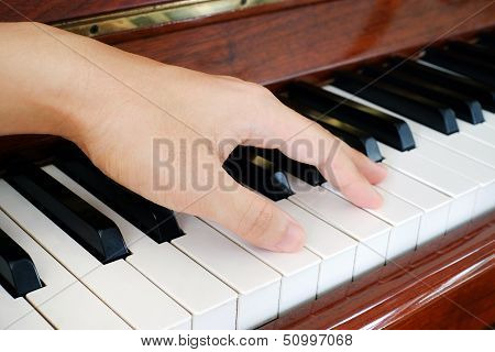 A hand on a piano
