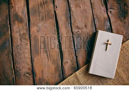 Image of Christian book with cross on its cover on wooden background 