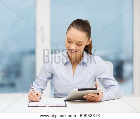 office, business, technology and internet concept - businesswoman with tablet pc and documents in office