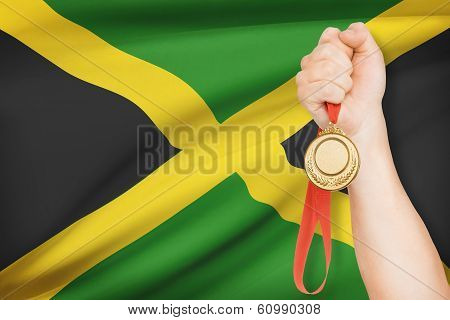 Medal In Hand With Flag On Background - Jamaica