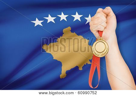 Medal In Hand With Flag On Background - Kosovo