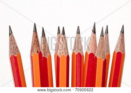 Assorted graphite pencils stacked vertically with white background