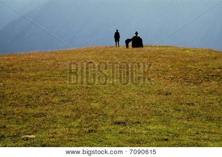 Praying people on a top of a hill