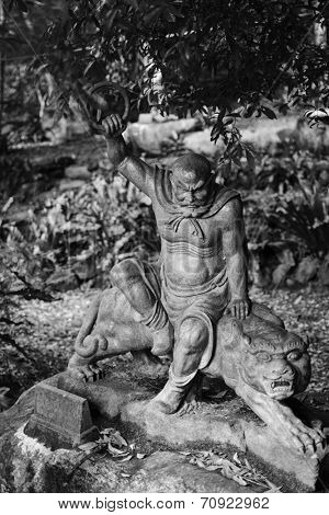 Old ruined Arhat Kanakbharadvaja statue in forest, Taiwan, Asia.