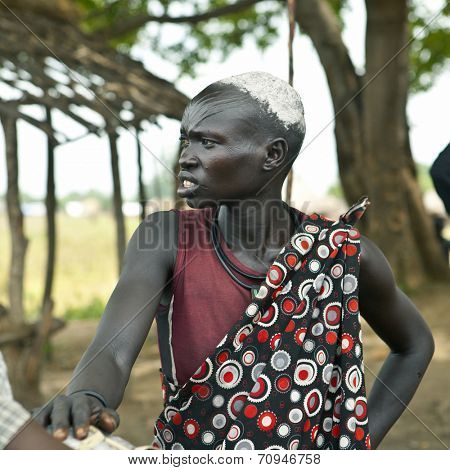 MANGALLA, SOUTH SUDAN-JUNE 22 2012: Unidentified Dinka woman with tribal scarification in South Sudan