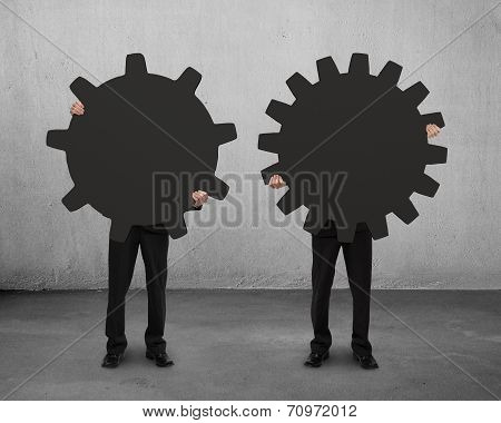 Two Men Holding Their Different Gear