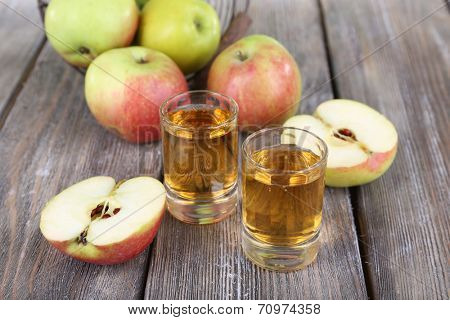 Still life with tasty apple cider in barrel and fresh apples
