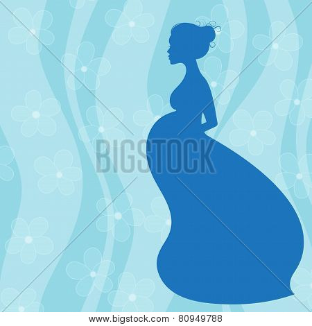 Pregnant woman in long dress on blue floral background