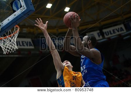 VALENCIA, SPAIN - JANUARY 21: Cooper with ball and Aguilar during Eurocup match between Valencia Basket Club and CSU Asesoft at Fonteta Stadium on January 21, 2015 in Valencia, Spain