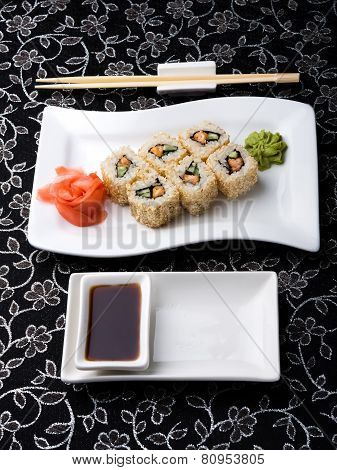 California Rolls Sushi With Pickled Ginger, vasabi And Soy Sauce In The Plate