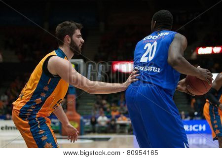 VALENCIA, SPAIN - JANUARY 21: Cooper with ball and Dubljevic during Eurocup match between Valencia Basket Club and CSU Asesoft at Fonteta Stadium on January 21, 2015 in Valencia, Spain