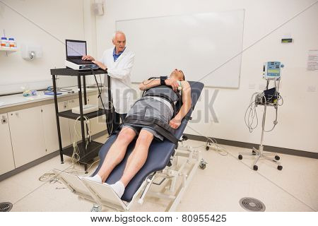 Man lying on gurney to find out his BMR at the medical centre