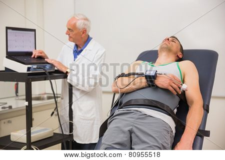 Man lying on gurney to find out his BMR at the medical centre