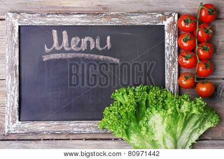 Blackboard menu on rustic wooden planks background